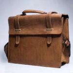 Old brown leather suitcase on white background. Bag for put the camera and other.