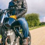 Unrecognizable young man riding a custom motorbike outdoors