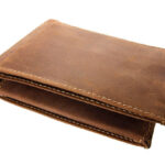 Empty brown leather wallet isolated on white background.